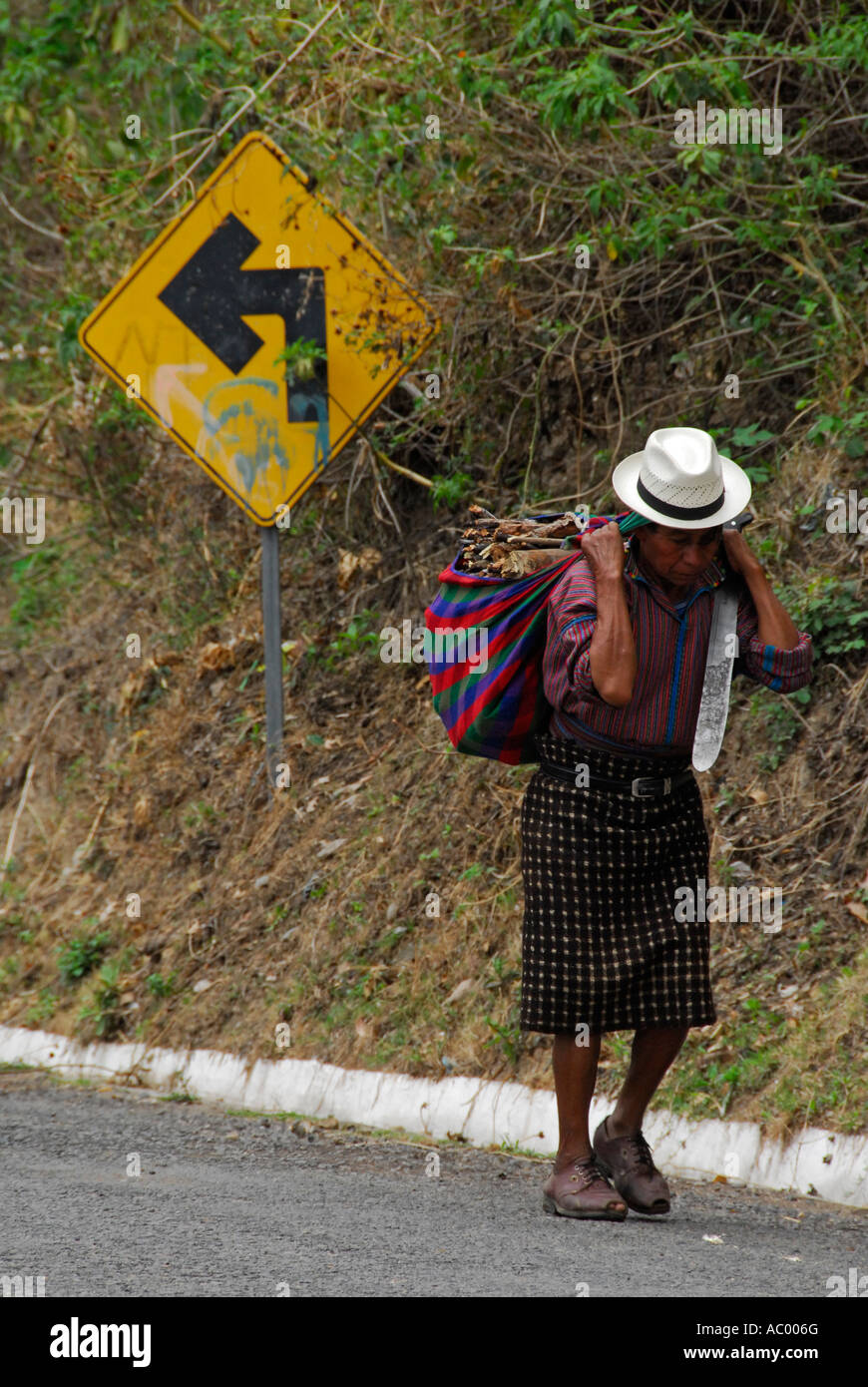 Indigenous man walking down the road, San Antonio Palopo, Lake Atitlan, Guatemala, Central America Stock Photo