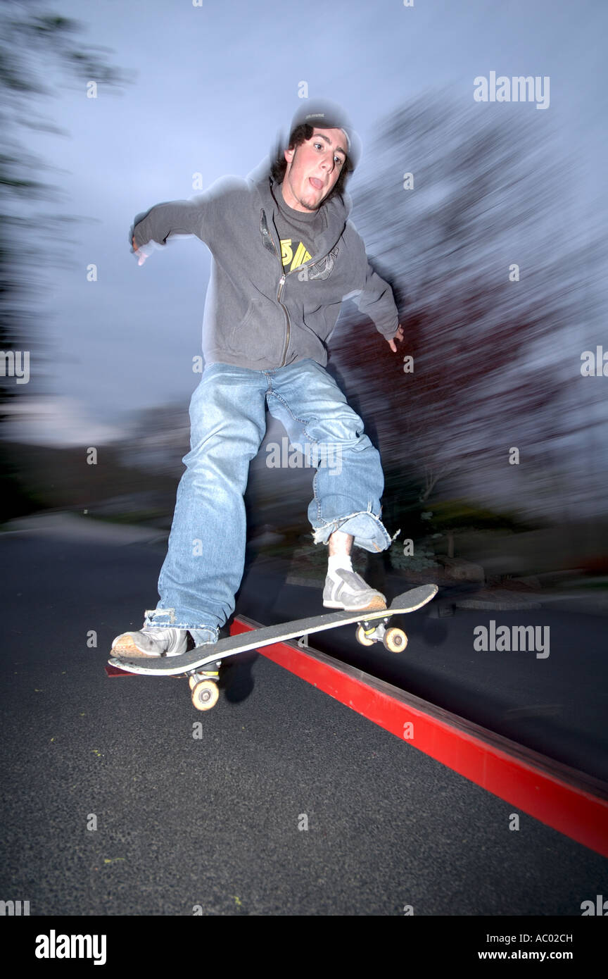 Young man performing trick on skateboard Stock Photo