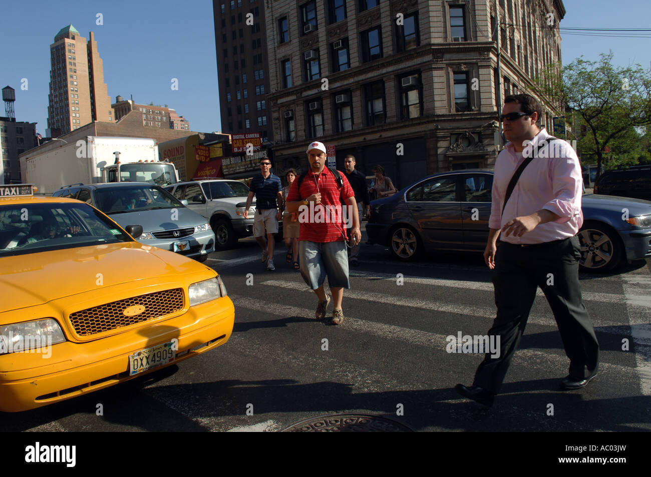 Pedestrians cross Seventh Ave intersection in Greenwich Village in NYC Stock Photo