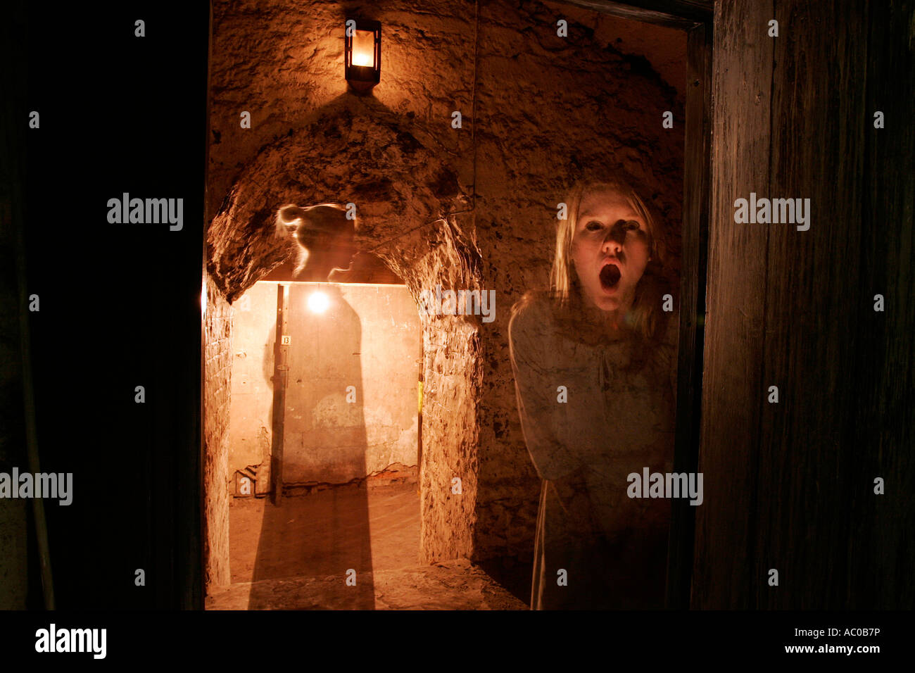 The ghostly figures of two girls standing in a doorway in the Real Mary King's Close, a tourist attraction in Edinburgh Stock Photo