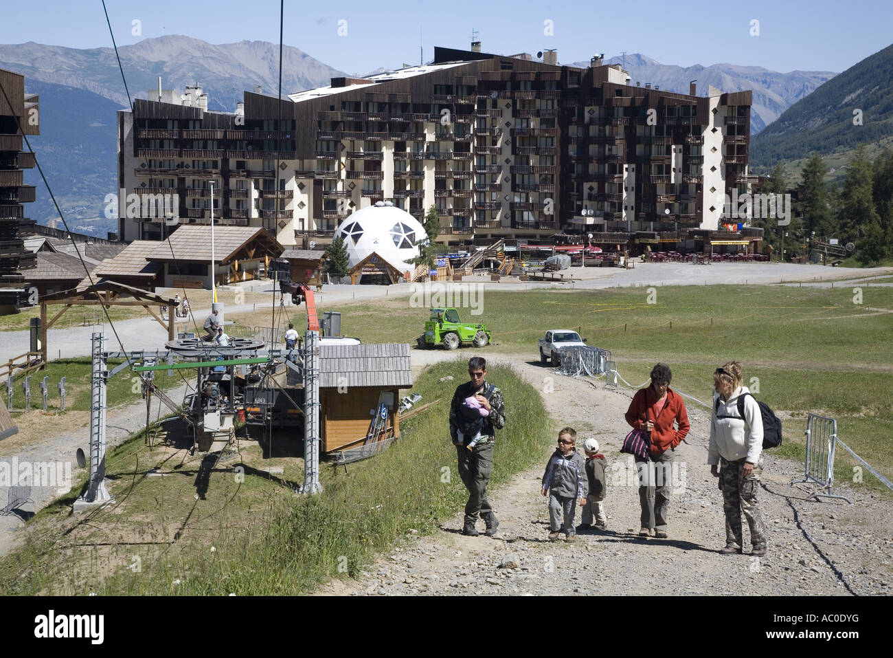 Tourists walking in a ski resort in summer, Les Orres, Hautes Alpes, France Stock Photo