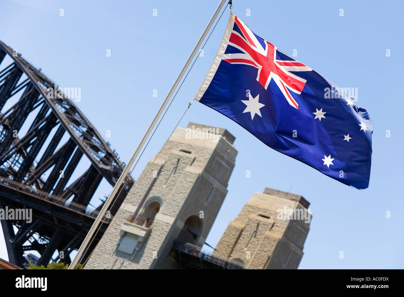 An Australian flag flutters in the breeze in front of the iconic Sydney Harbour Bridge Stock Photo