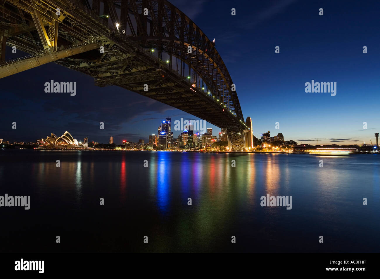 The Opera House and skyline of central Sydney is framed by the Harbour Bridge at Milsons Point Stock Photo