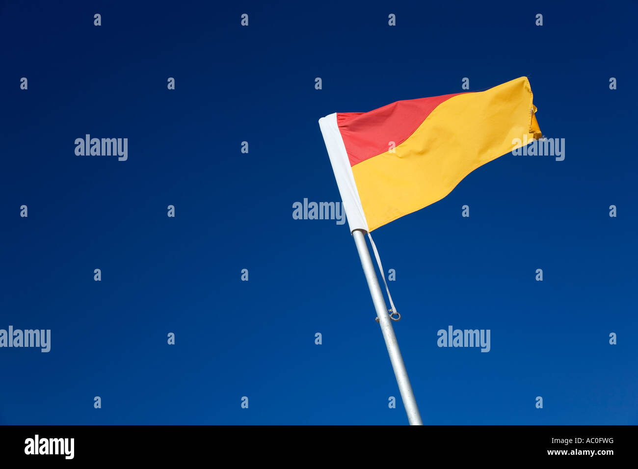 The iconic red and yellow flag of Australian lifesaving Pairs of flags Stock Photo