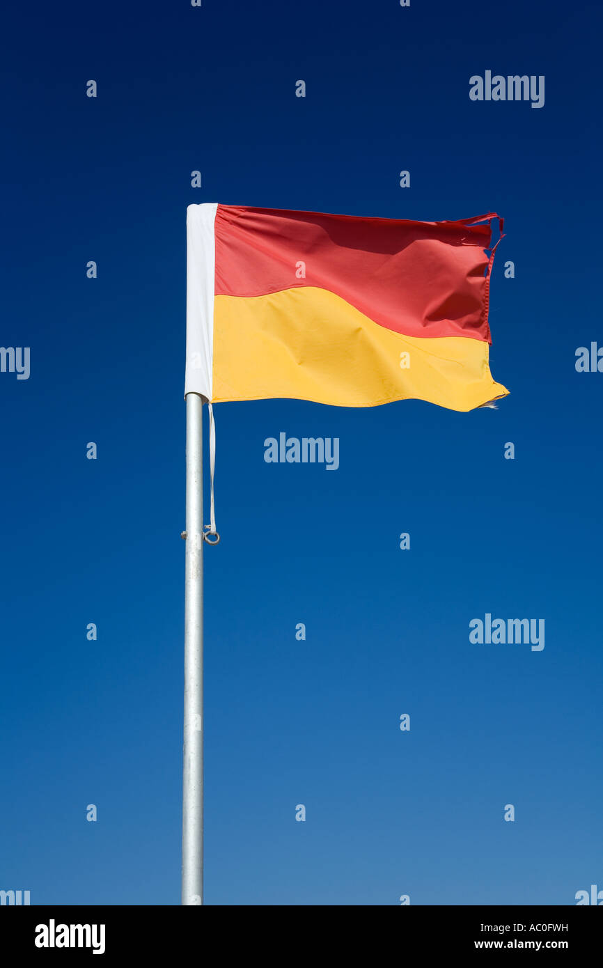 The iconic red and yellow flag of Australian lifesaving Pairs of flags Stock Photo