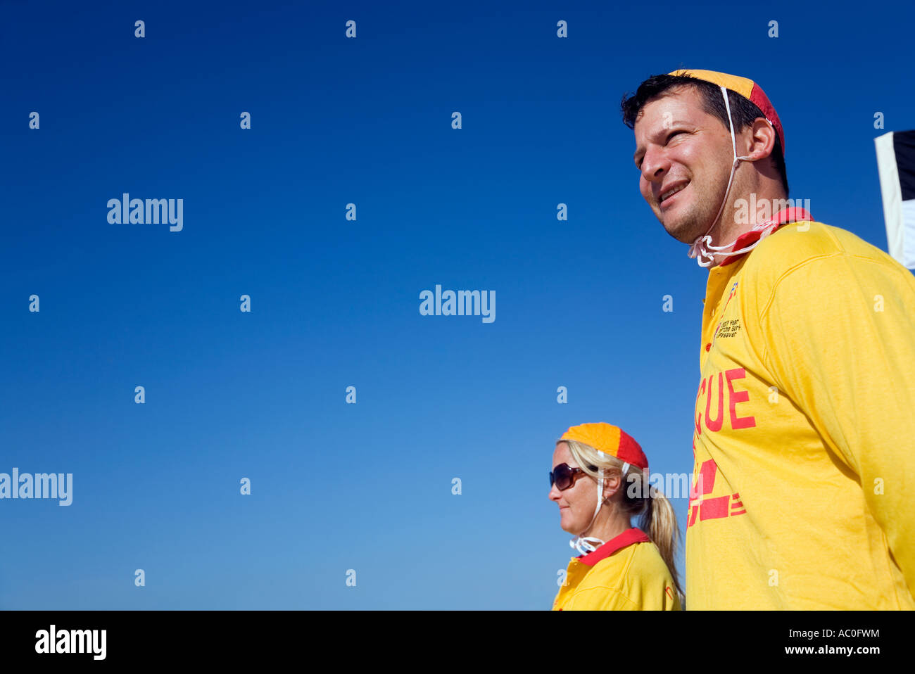 Surf lifesavers in traditional red and yellow watch the surf at Bondi Beach for swimmers in distress Stock Photo