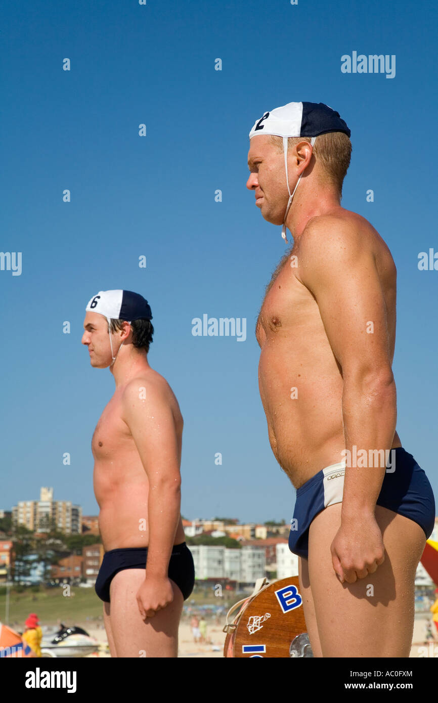 Members of the Bondi Surf Bathers Life Savering Club stand at the ready during a training rescue with traditional reel and line Stock Photo