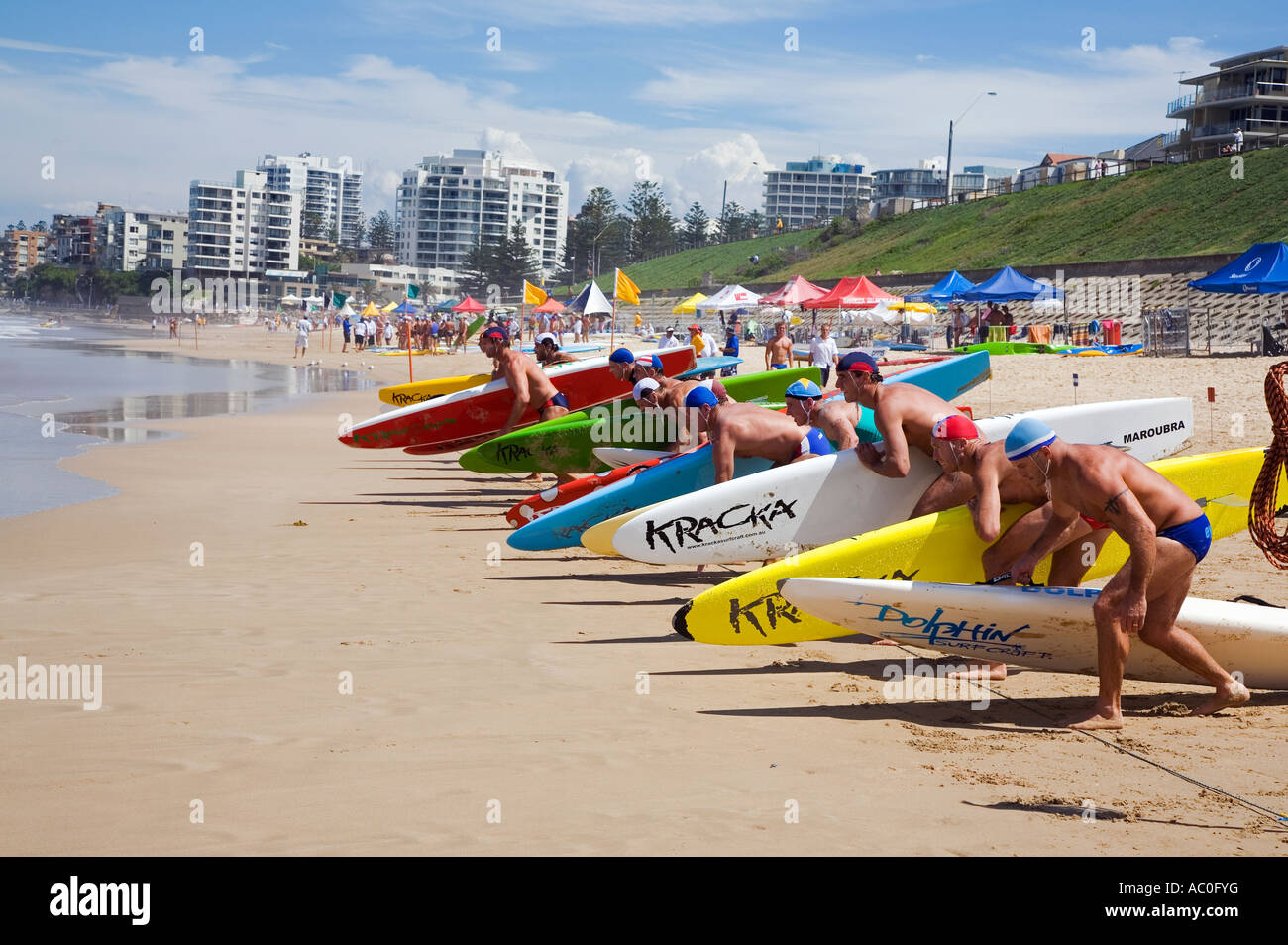 Competitors line up for the start of a rescue board race on Cronulla Beach Stock Photo