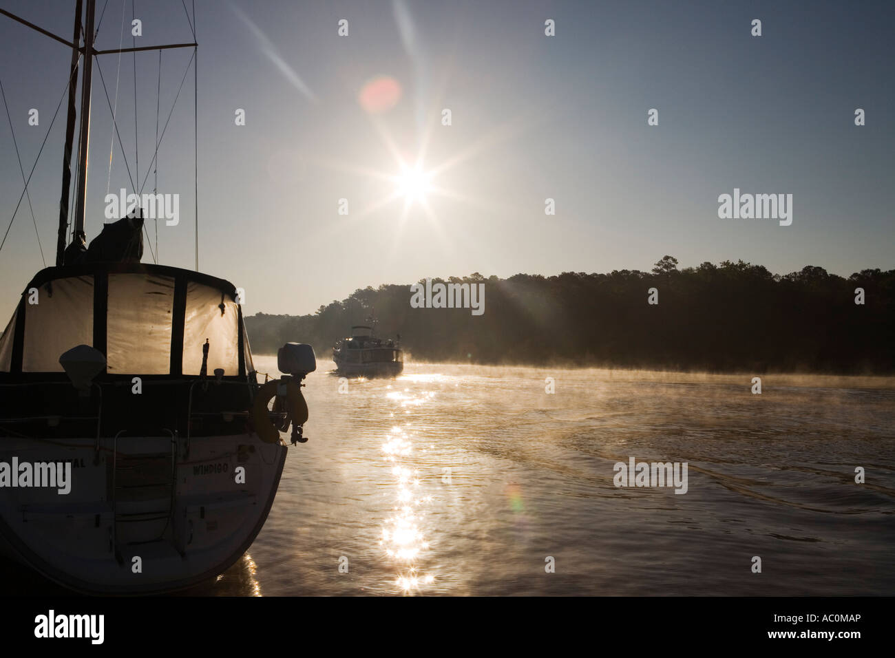 A sailboat at sunrise Stock Photo - Alamy