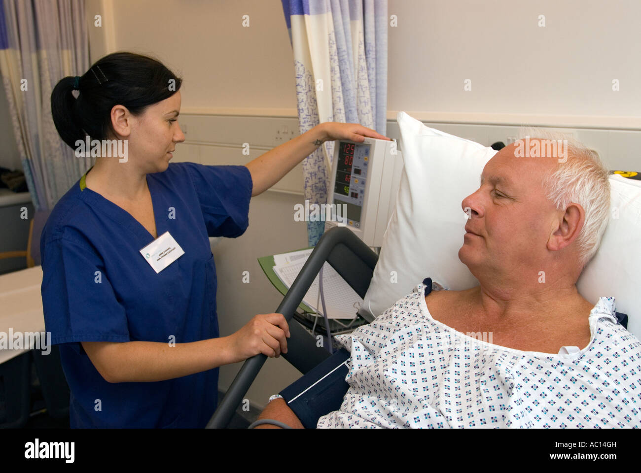Healthcare Assistant monitoring post operative patients vital signs at