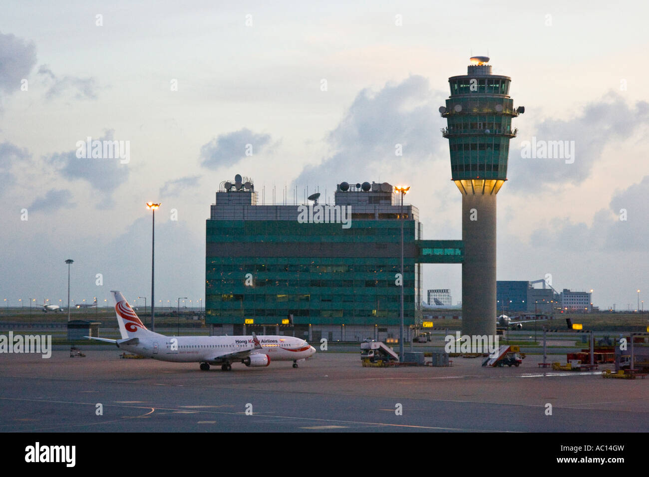Departing Flight and Conning Air Traffic Control Tower HKG Hong Kong International Airport Hong Kong SAR Stock Photo