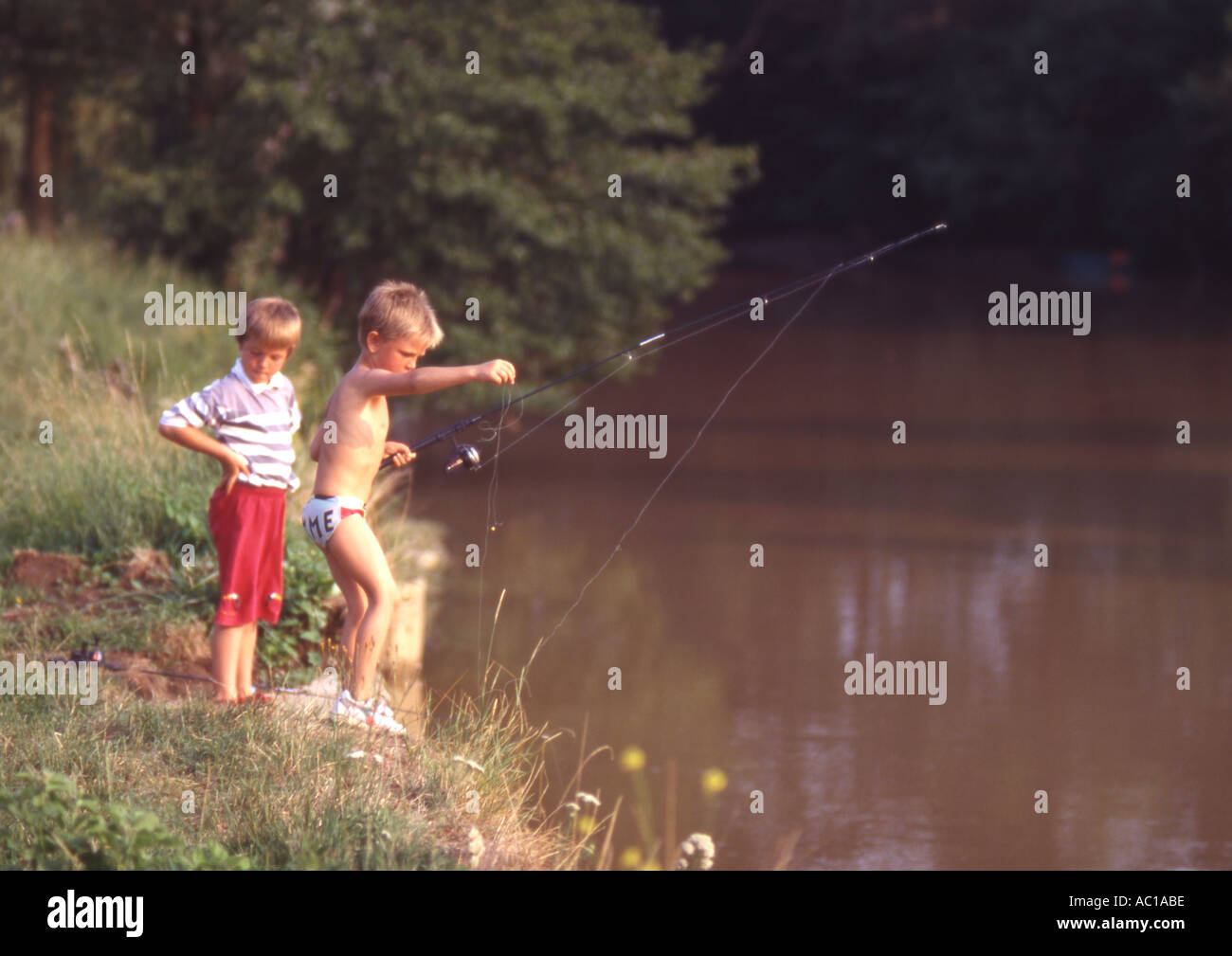 Two boys fishing in river hi-res stock photography and images - Alamy