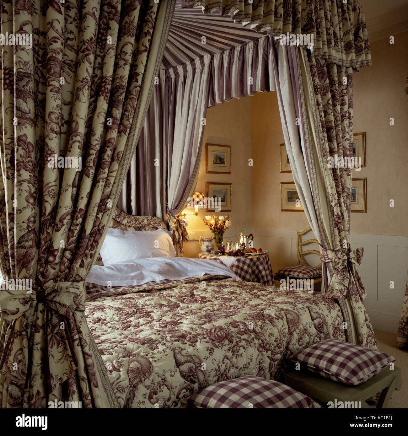 Four poster bed with fabric canopy and matching quilted bed cover