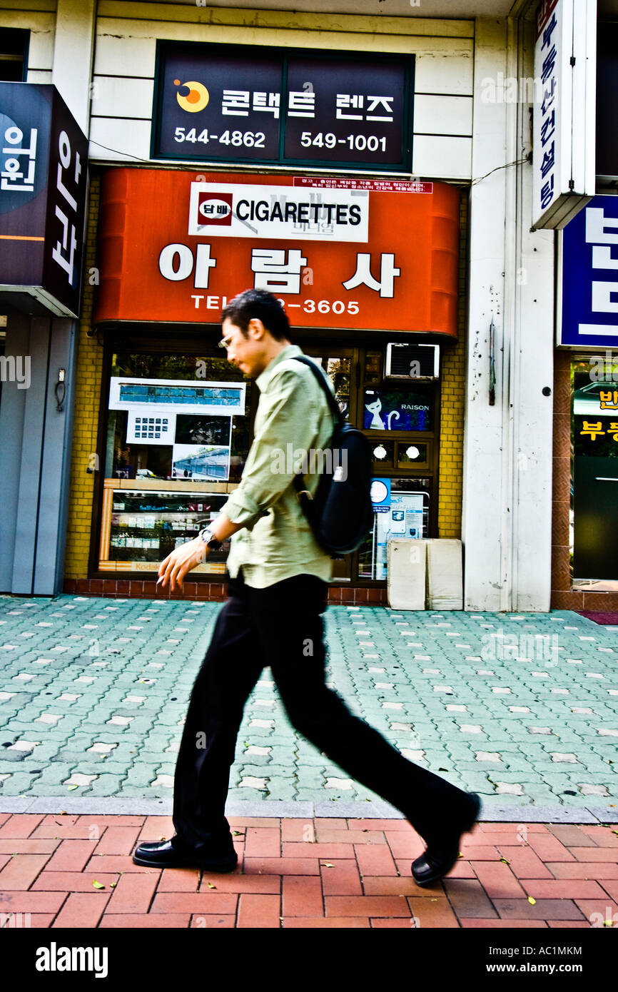 Cigarette Smoker Walking past Tobacco Shop Seoul South Korea Stock