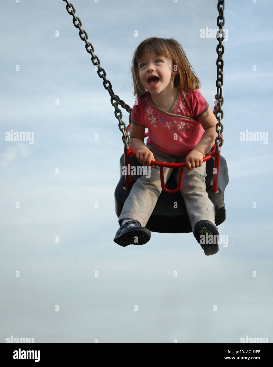 Girl laughing on swing hi-res stock photography and images - Alamy