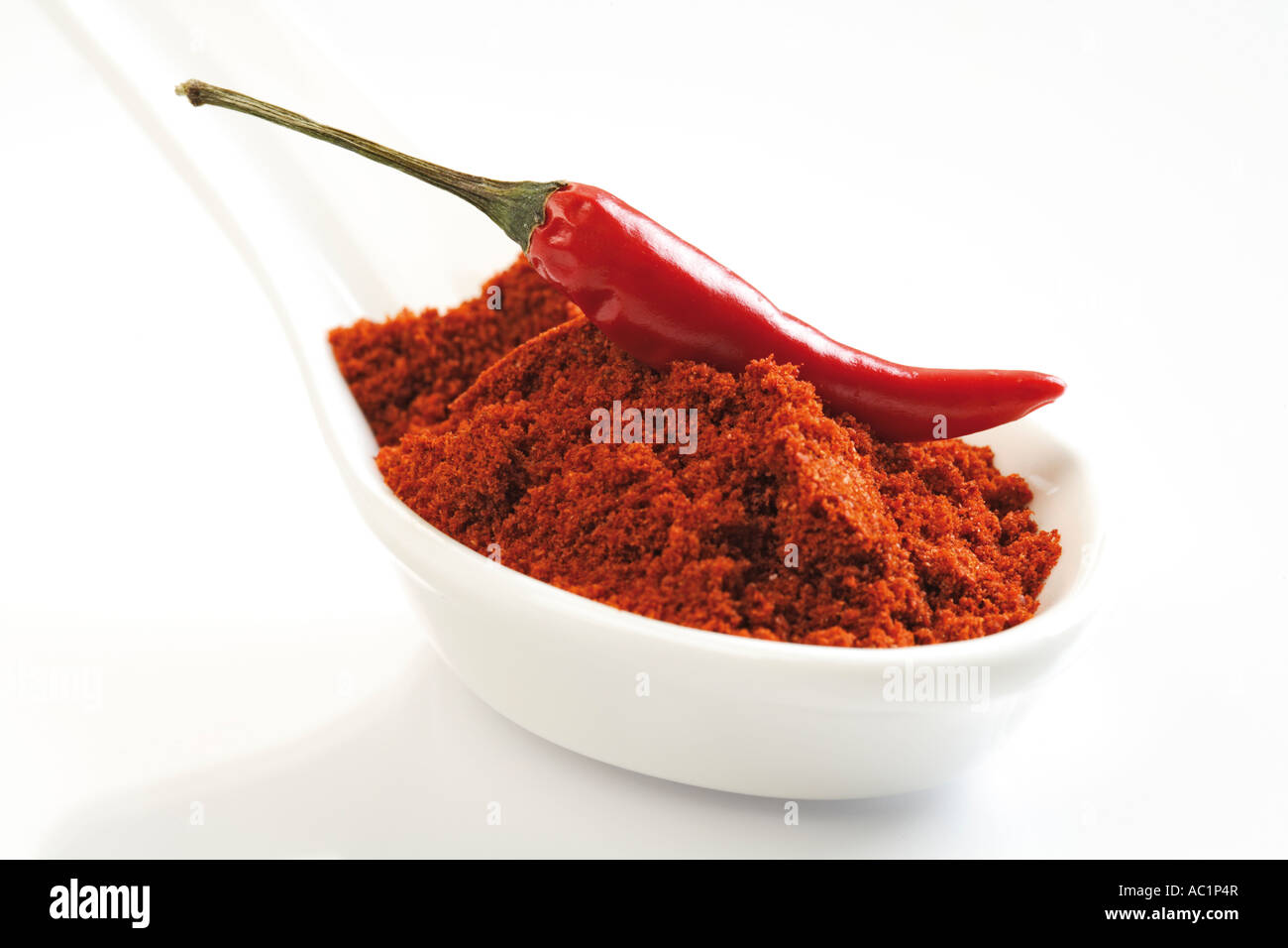Ground cayenne pepper and red chilli pod Stock Photo Alamy