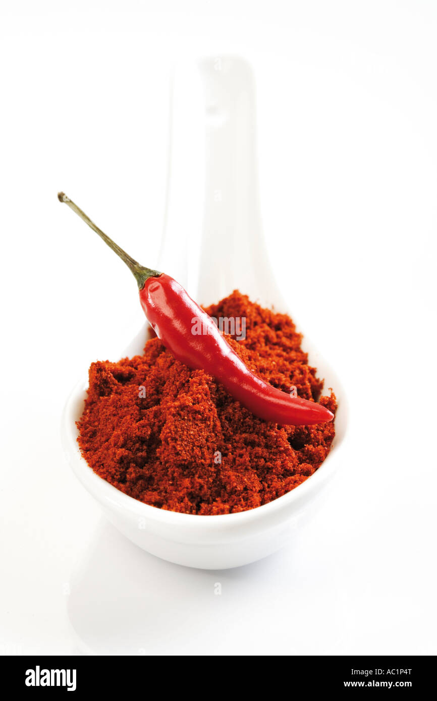 Ground cayenne pepper and red chilli pod Stock Photo Alamy