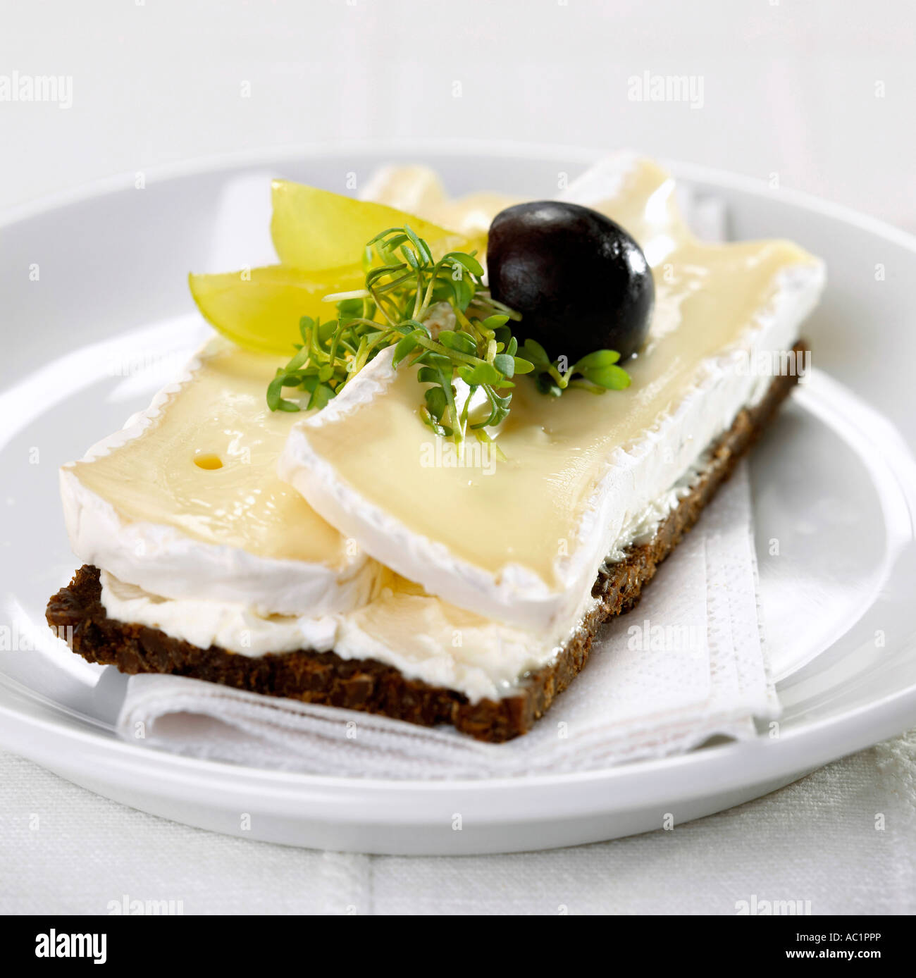 Wholemeal roll with Brie Stock Photo - Alamy