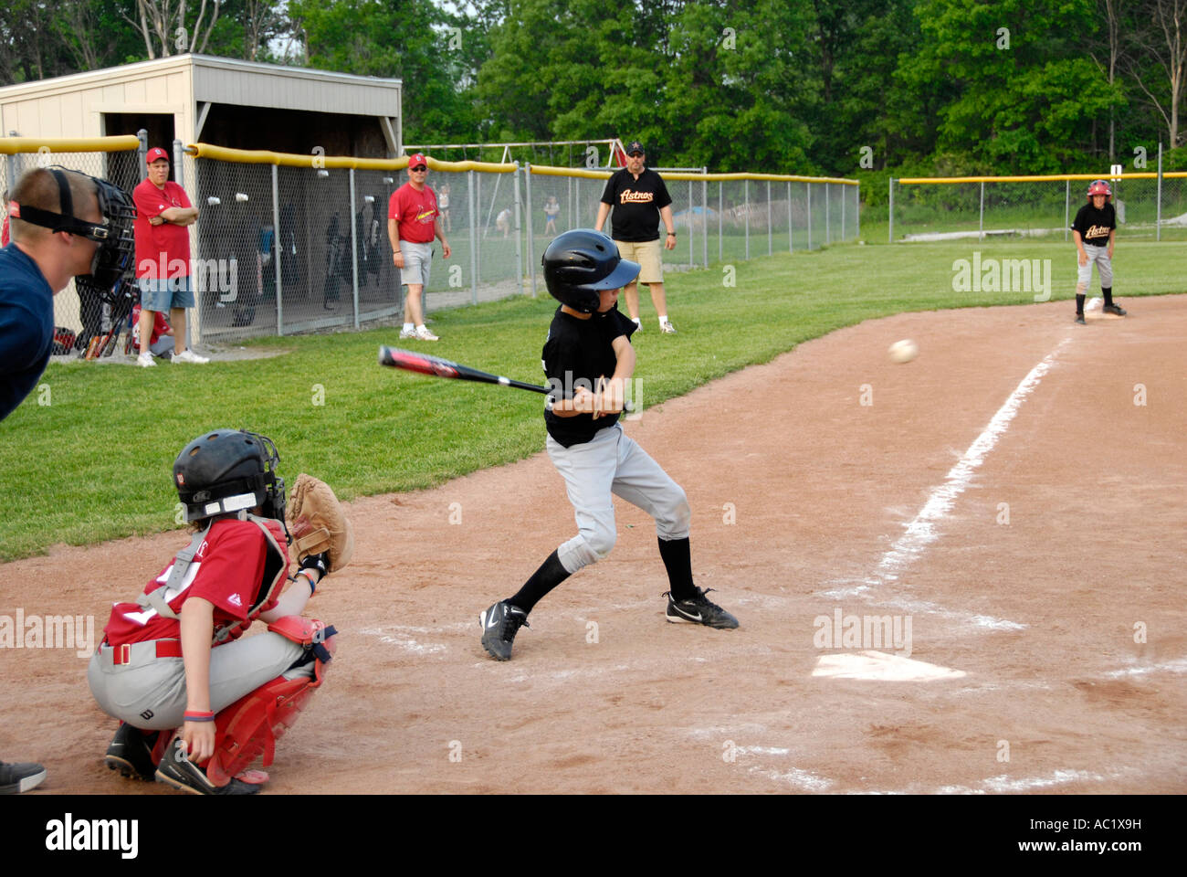 Little League baseball player hitting a ball Stock Photo Alamy