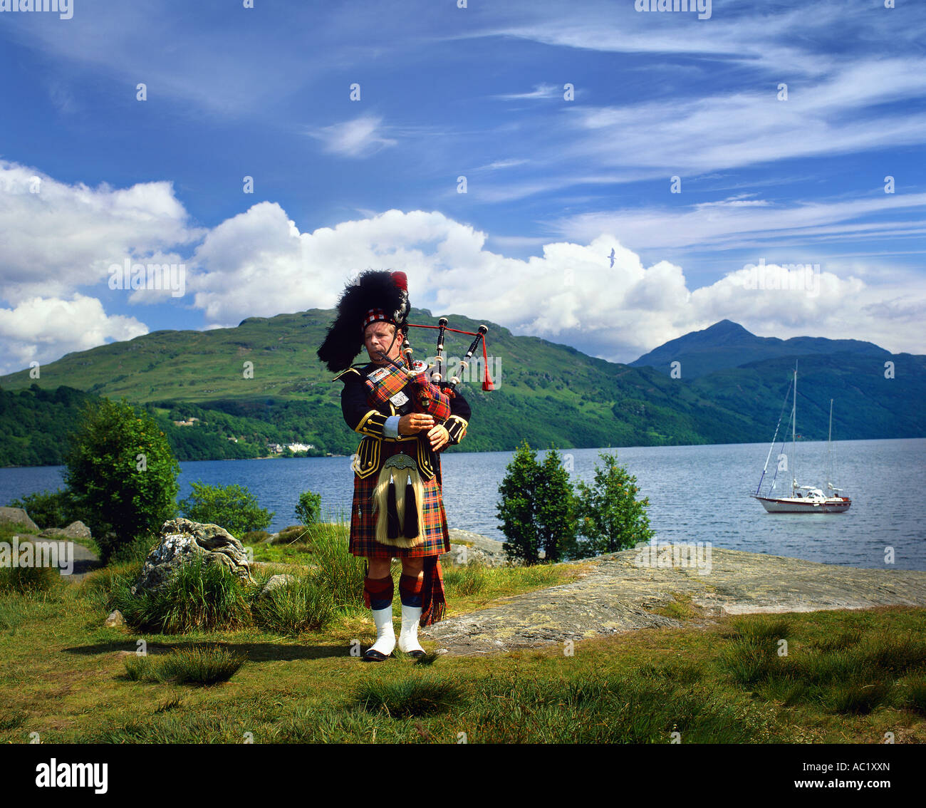GB SCOTLAND Scottish Piper at Loch Lomond Stock Photo Alamy