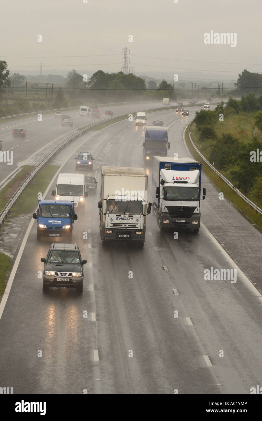 Cars and lorries driving in rain wet road conditions on M5 Motorway