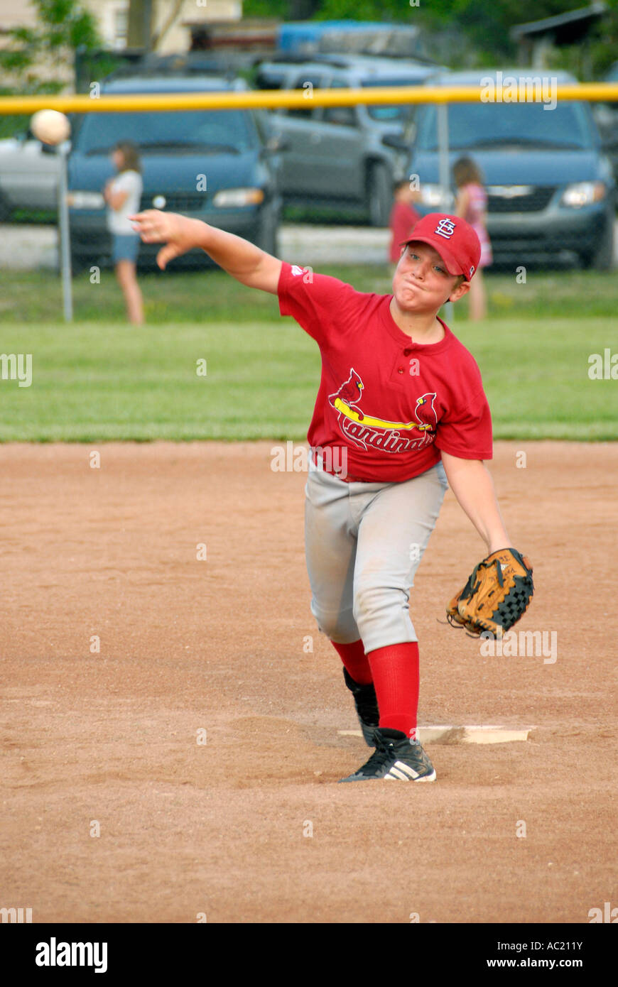 Little League baseball pitcher player throwing a baseball Stock Photo