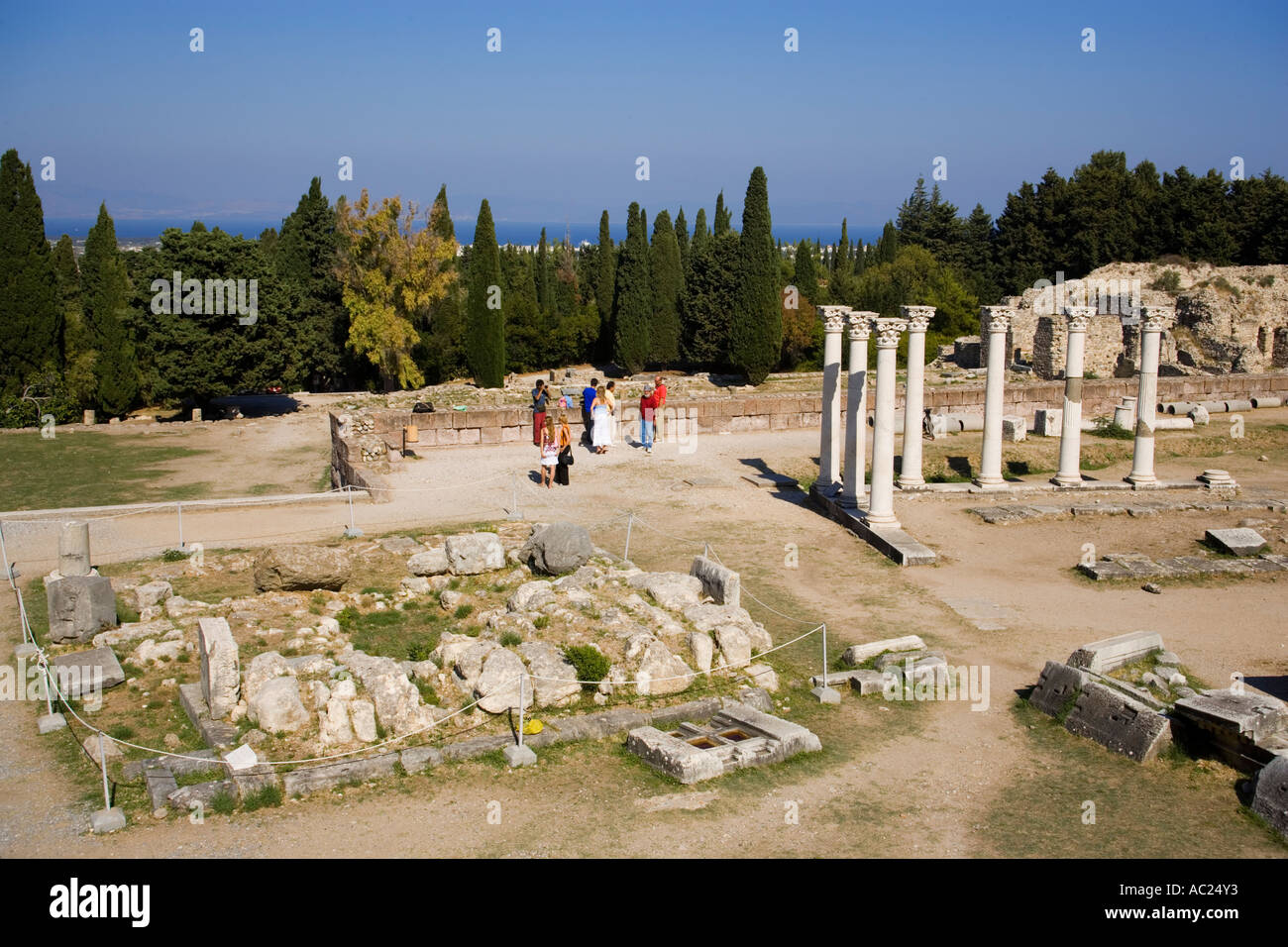 View to Altar of Asclepius and group of tourists in background at temple Asklipieion Kos Town Kos Greece Stock Photo