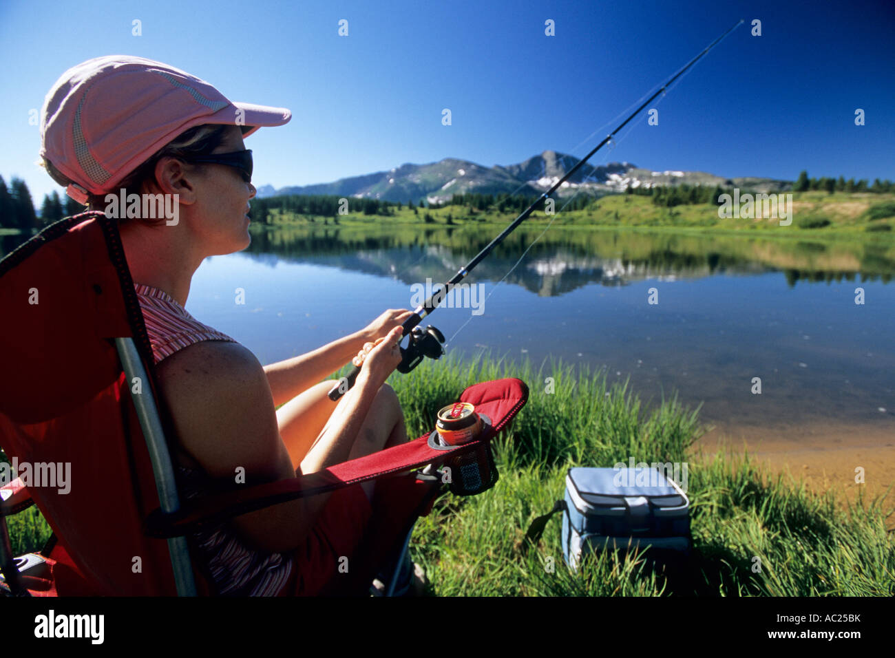 https://c8.alamy.com/comp/AC25BK/woman-fishing-by-lake-AC25BK.jpg
