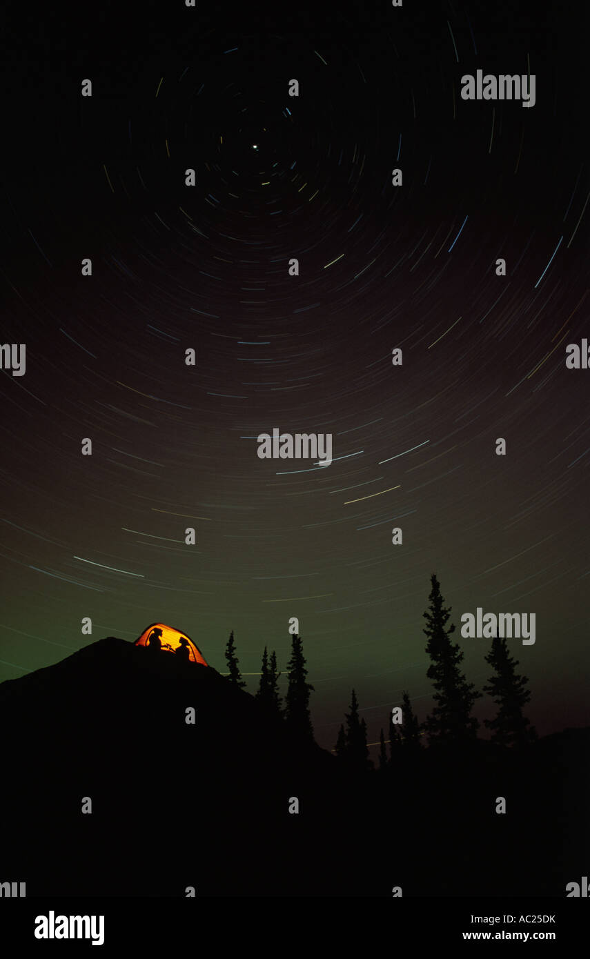Illuminated tent in forest starry night Stock Photo - Alamy