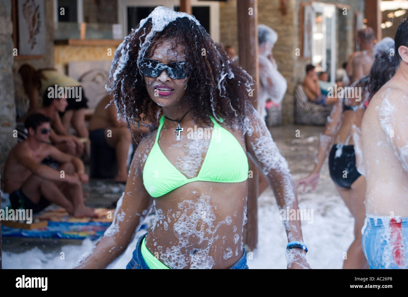 Woman dancing by a foam party of the Paradise Club at Paradise Beach Mykonos Greece Stock Photo
