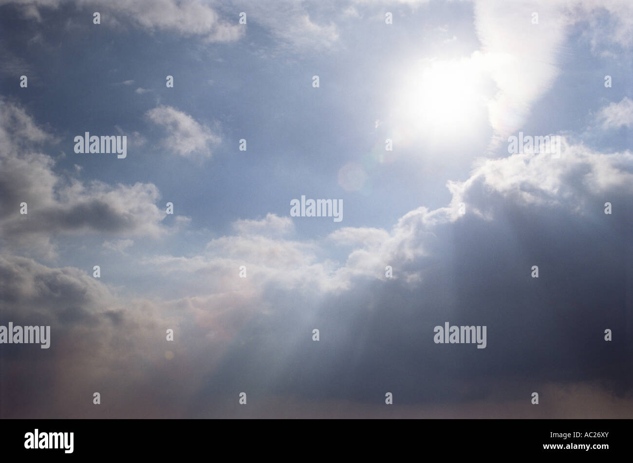 Sun shining through clouds with sunrays Stock Photo - Alamy