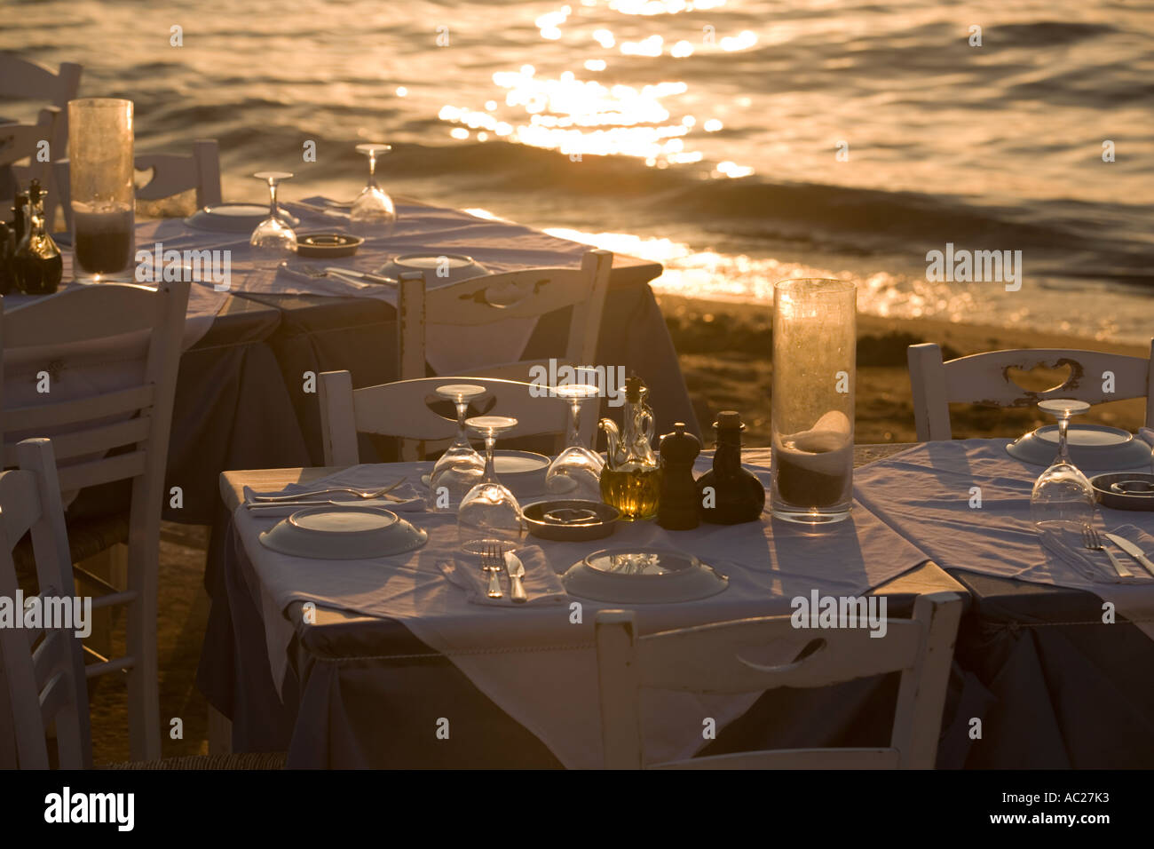 Table with glasses and plates at bank Little Venice Mykonos Town Mykonos Greece Stock Photo