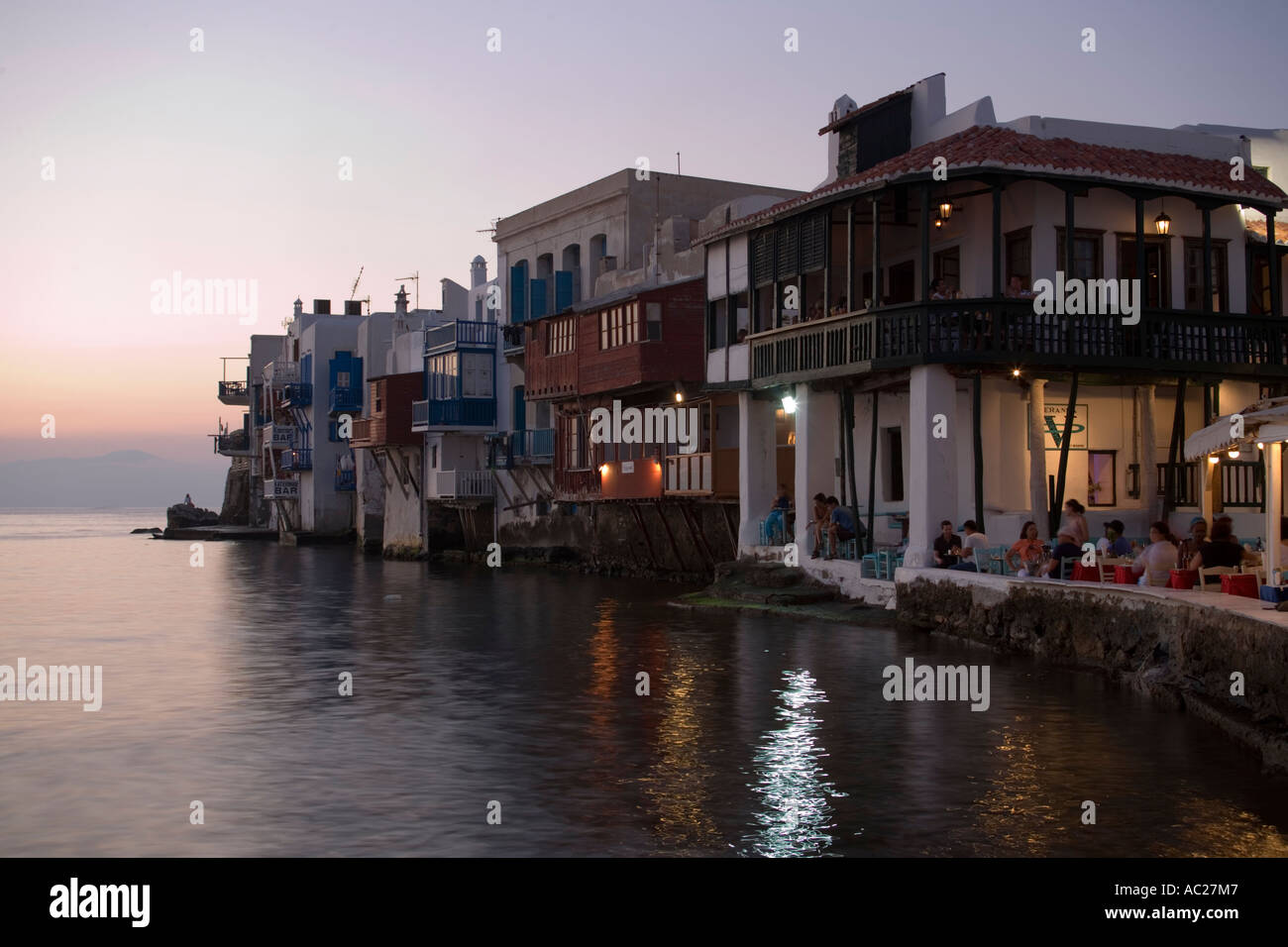 View along bank with restaurants and bars in the evening Little Venice Mykonos Town Mykonos Greece Stock Photo