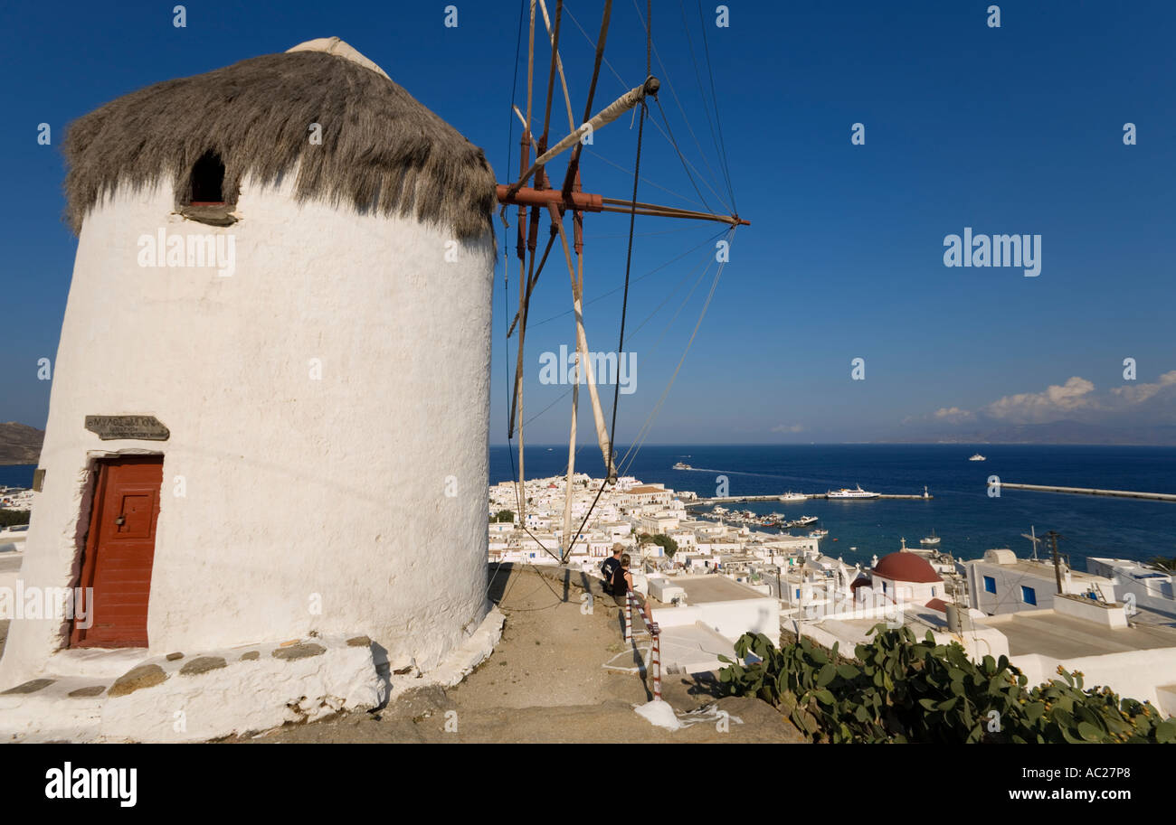 View from hill with famous traditional windmill over the town to the sea with ships Mykonos Town Mykonos Greece Stock Photo