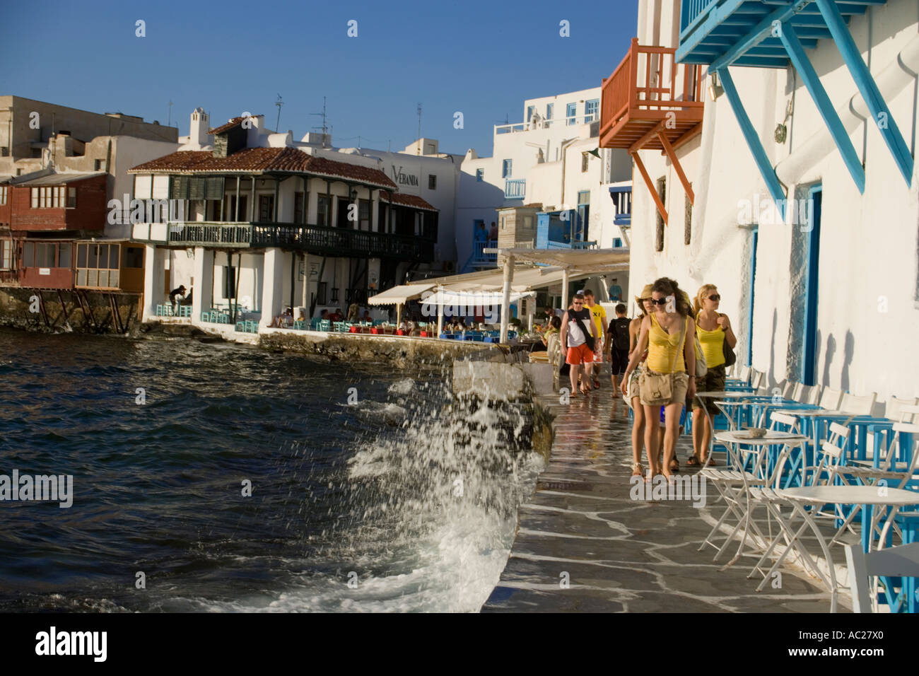 Women strolling along restaurants and bars at bank Little Venice Mykonos Town Mykonos Greece Stock Photo