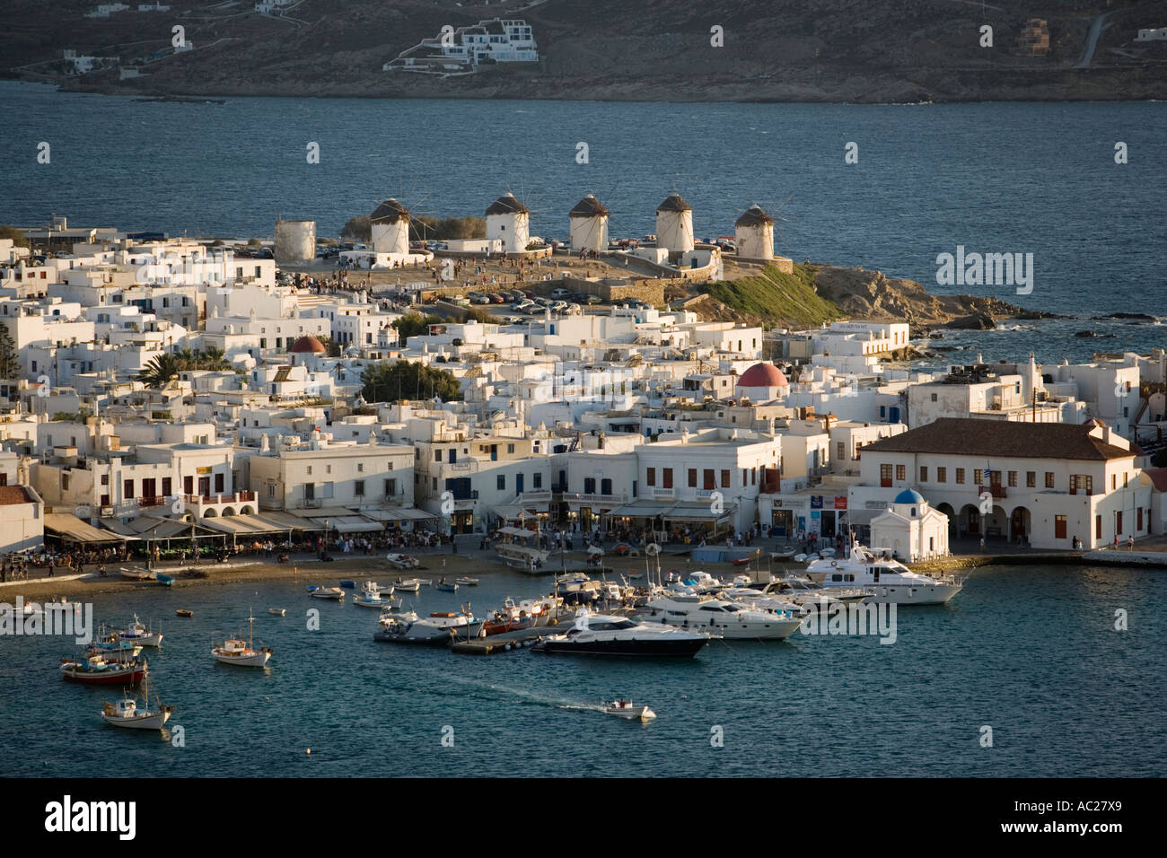 Aerial view of the harbour and the town with windmills in the evening Mykonos Town Mykonos Greece Stock Photo