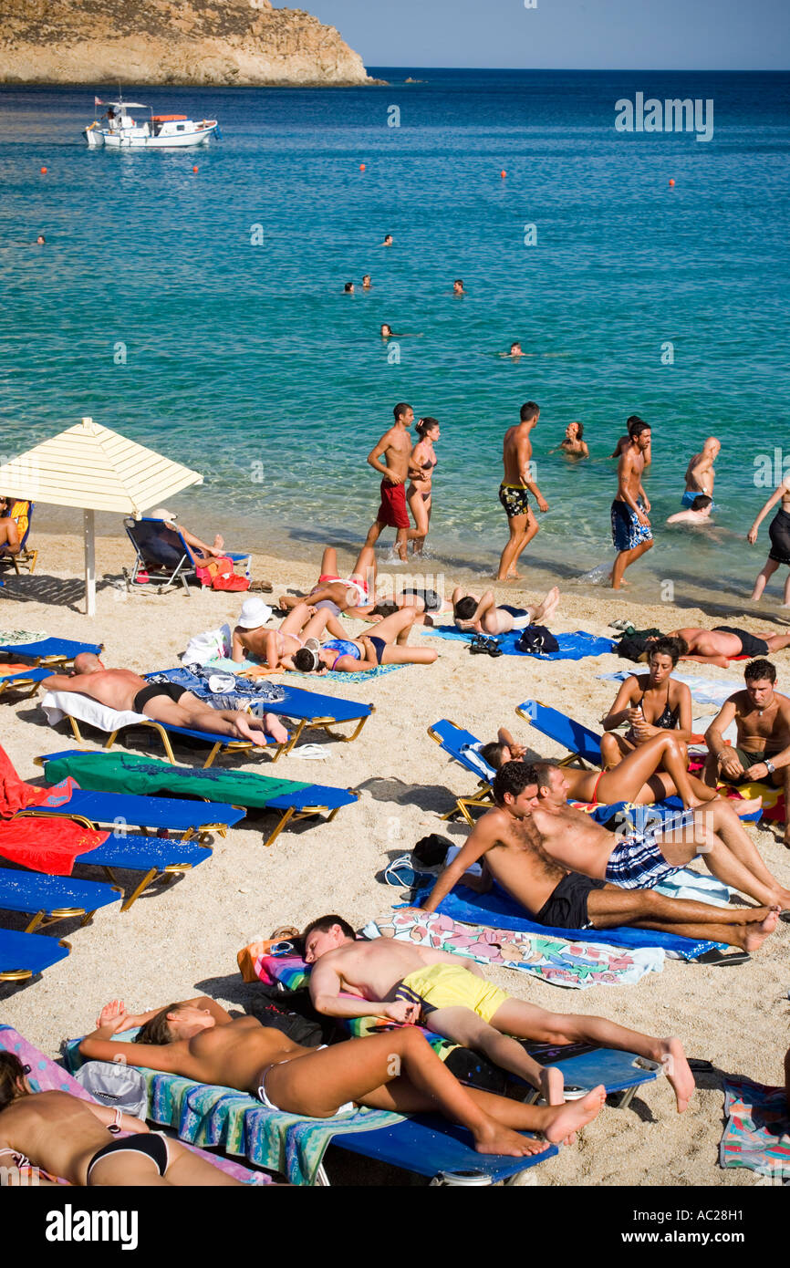 People at Super Paradise Beach knowing as a centrum of gays and nudism Psarou Mykonos Greece Stock Photo