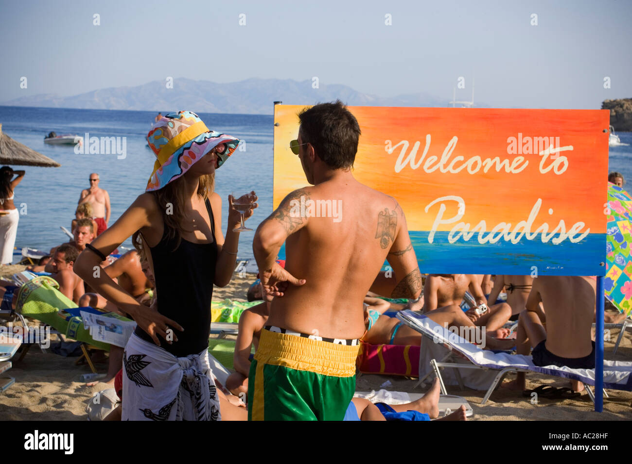 People at Super Paradise Beach knowing as a centrum of gays and nudism Psarou Mykonos Greece Stock Photo