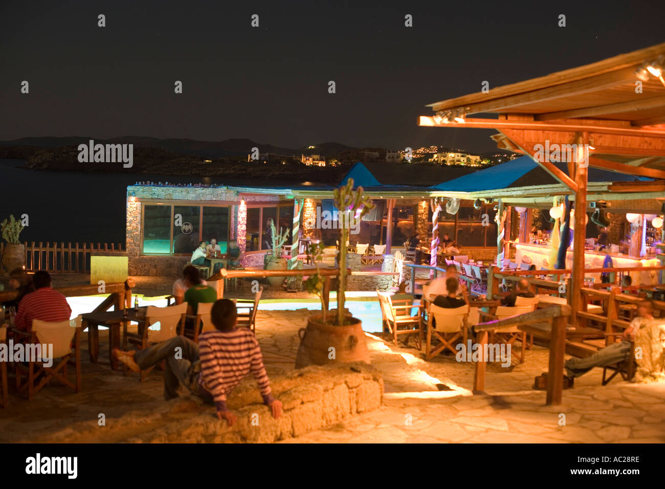 Tourists sitting in the open air club of Cavo Paradiso Paradise Beach  Mykonos Greece Stock Photo - Alamy