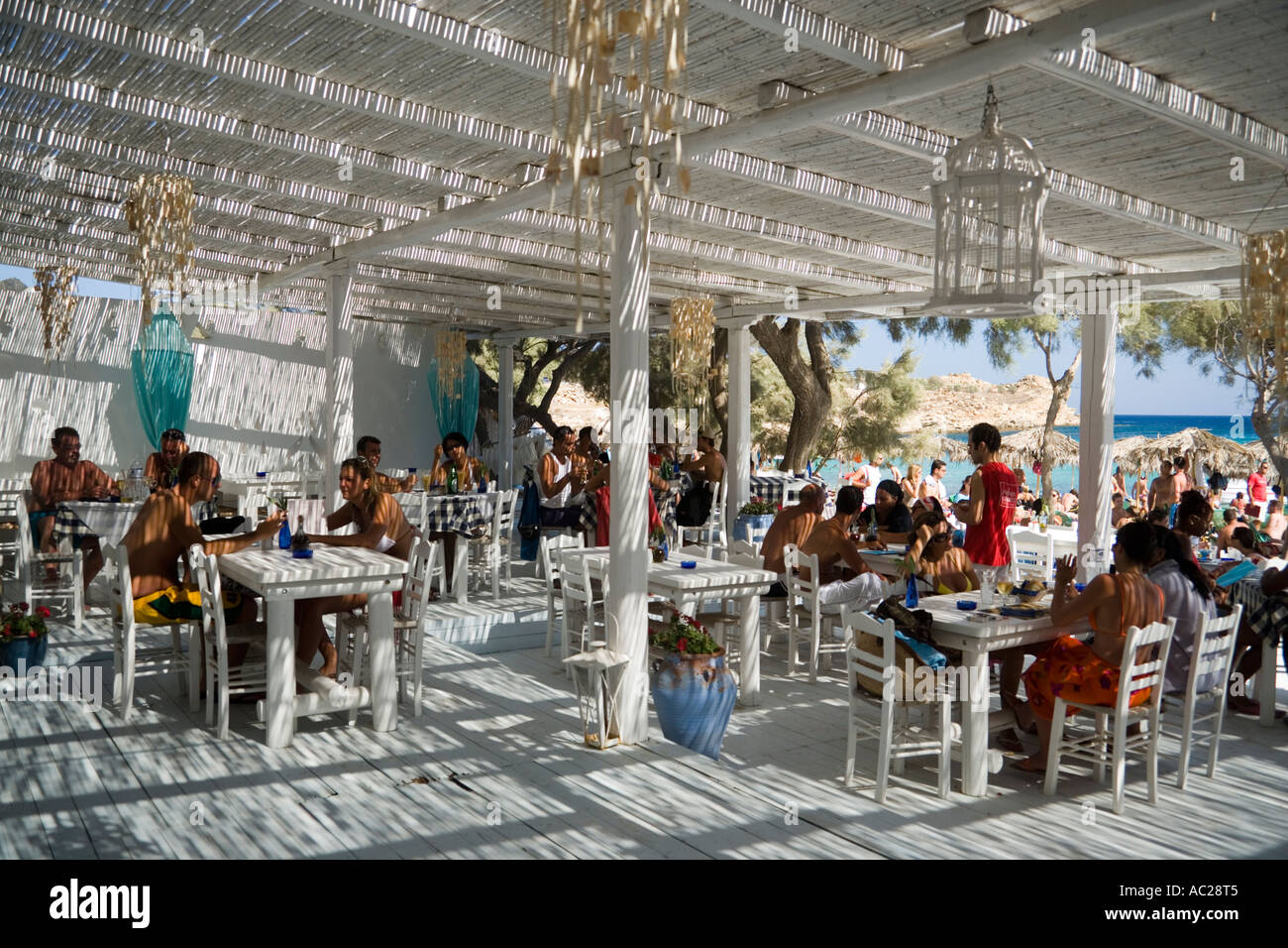 People sitting in the beach bar at the Paranga Beach Mykonos Greece Stock Photo