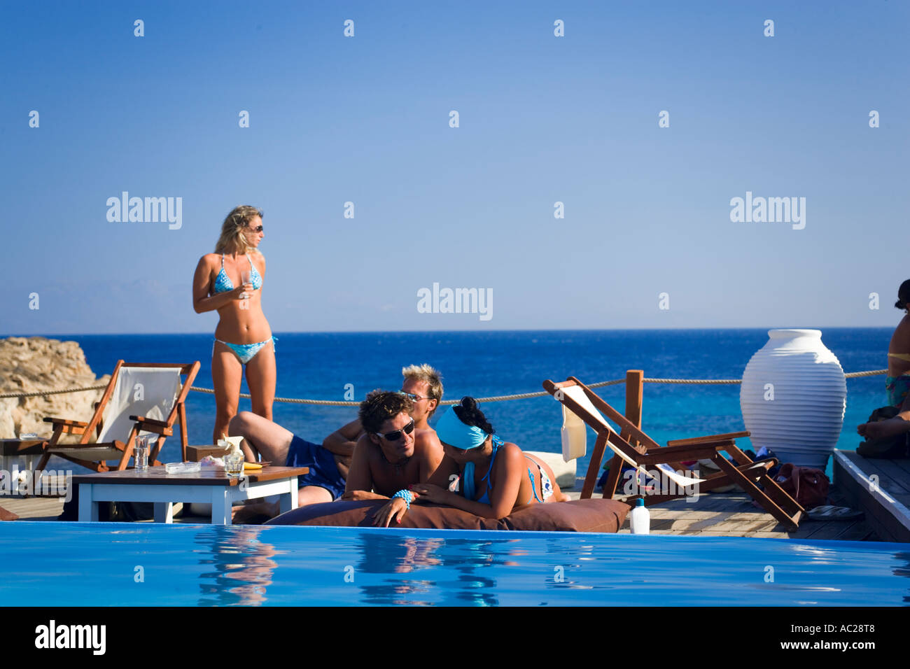 Women at the pool of the Goya Beach Bar the only beach bar with pool at Paranga Beach Mykonos Greece Stock Photo