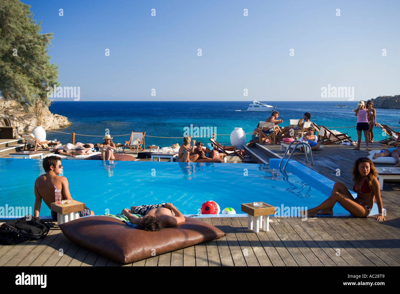 People at the pool of the Goya Beach Bar the only beach bar with pool at Paranga Beach Mykonos Greece Stock Photo