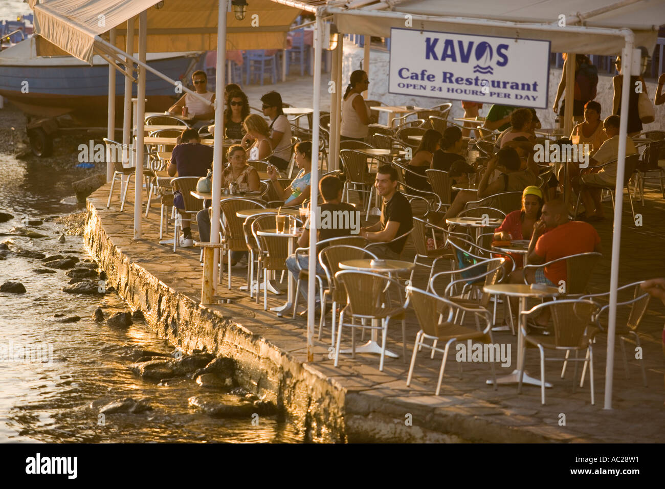 People sitting in Kavos Cafe and Restaurant at harbour Mykonos Town