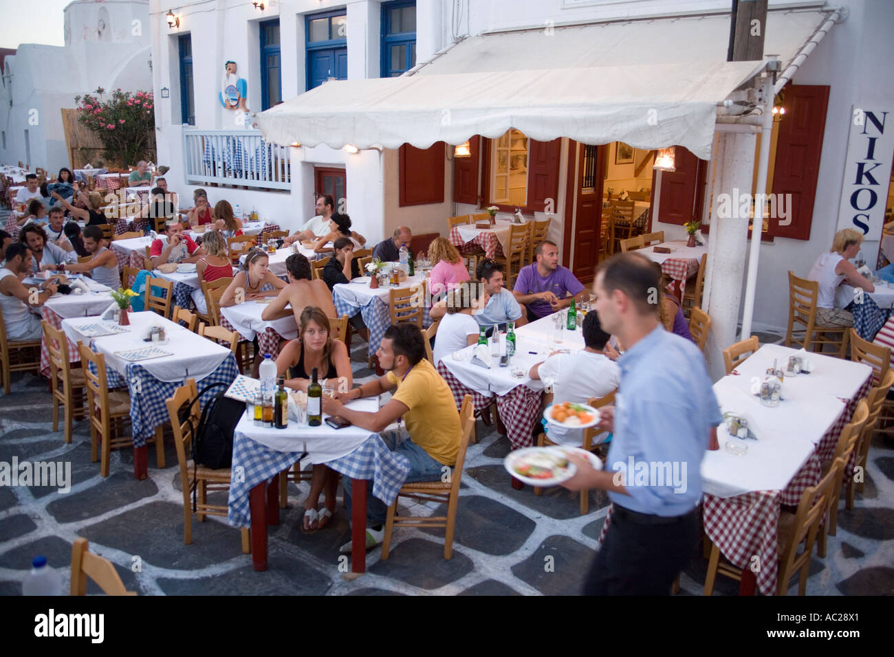 Waiter at Nikos typical Greek Tavern Mykonos Town Stock Photo