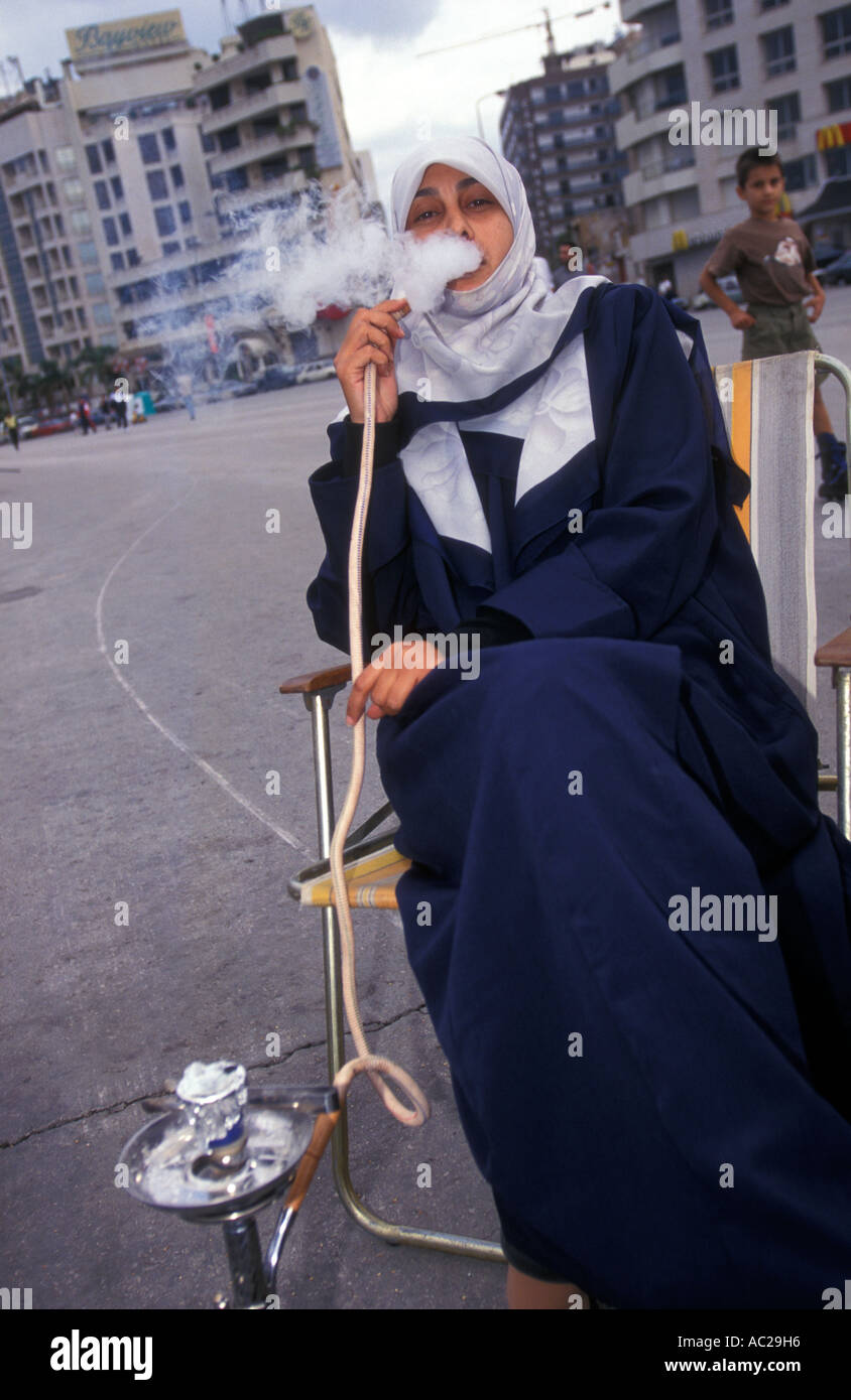 Arabic woman smoking Nargileh pipe or sheesha Corniche Beirut Lebanon