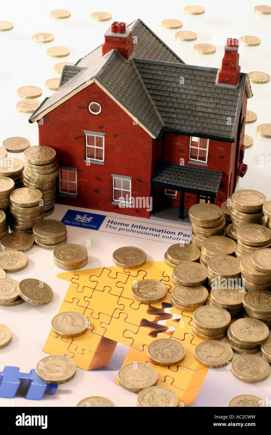 'Model house with pound coins with home info pack brochure' Stock Photo