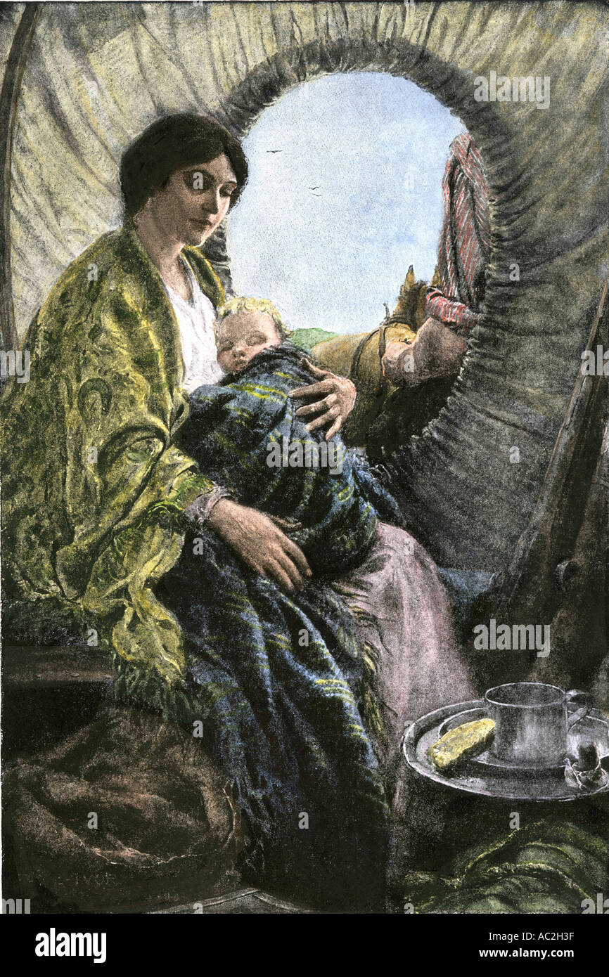 Madonna of the prairies a mother and child inside a covered wagon on the Oregon Trail 1800s. Hand-colored woodcut Stock Photo