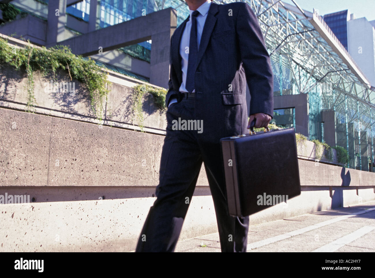 Businessman walks with briefcase Stock Photo