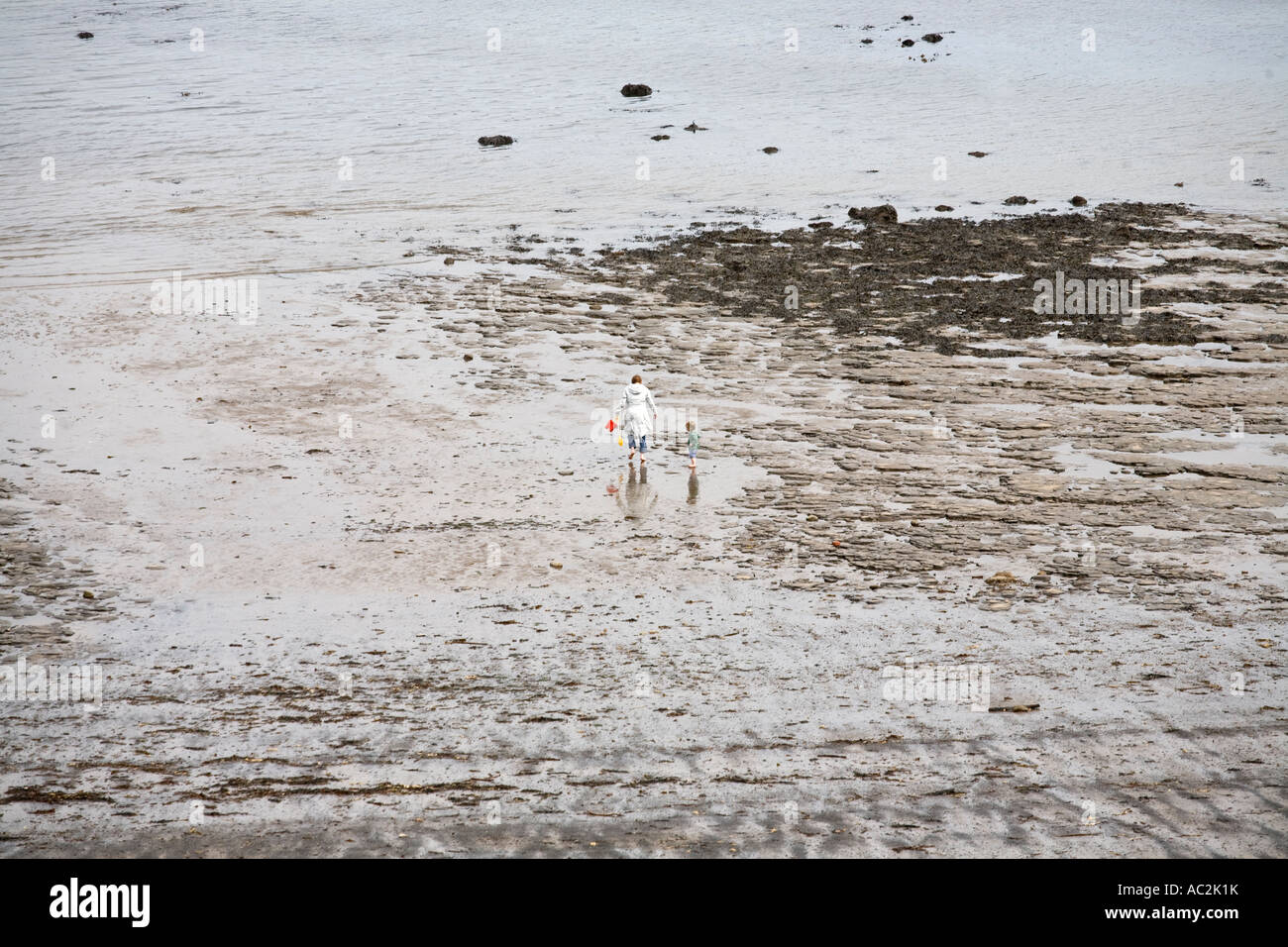 A mother and her young son on the beach at Runswick Bay in North Yorkshire England UK Stock Photo