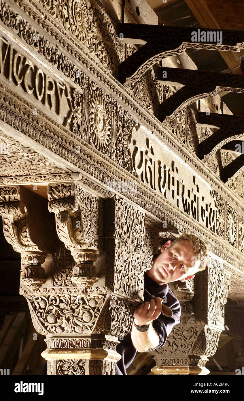 Skilled carpenter restoring an ornate Indian woodcarving in solid teak. Stock Photo